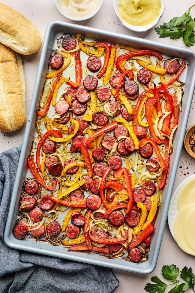 Cut up sausage, peppers, and onion baked on a sheet pan